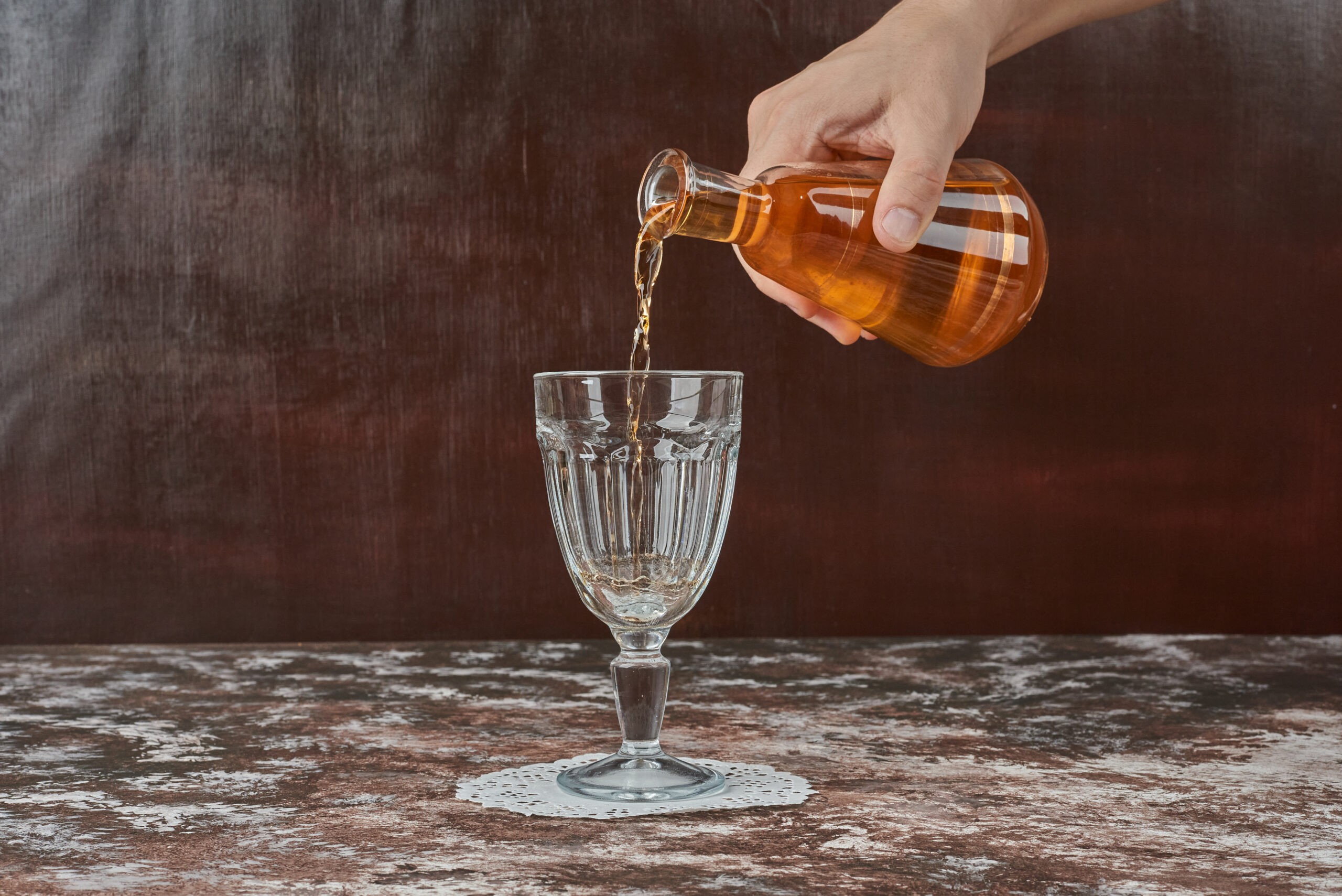 Putting drink into the glass. High quality photo